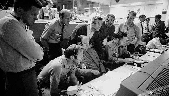 Black-and-white photo of NASA engineers in a control room