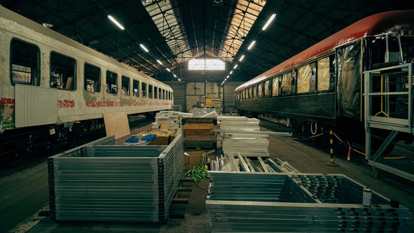 A train car is being built in a train yard.