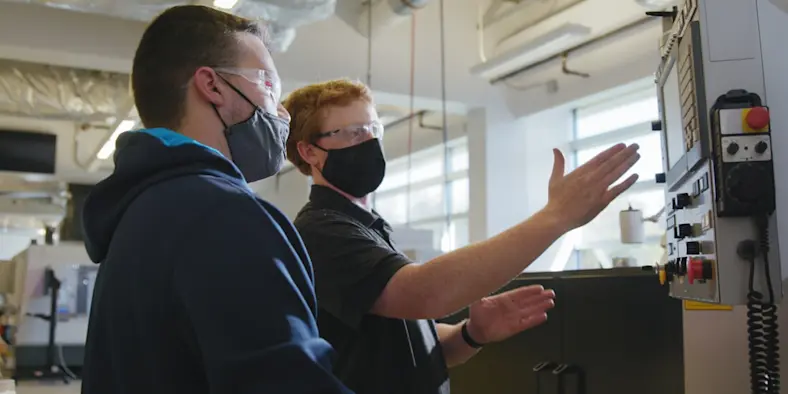 Advanced manufacturing training two young men in machining training lab