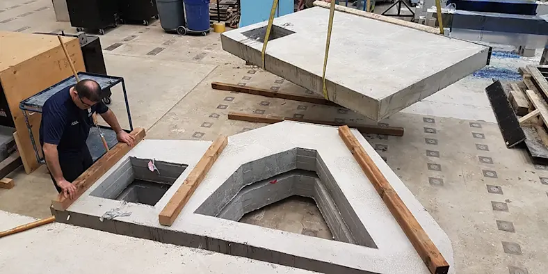 Concrete forms take shape in a factory.