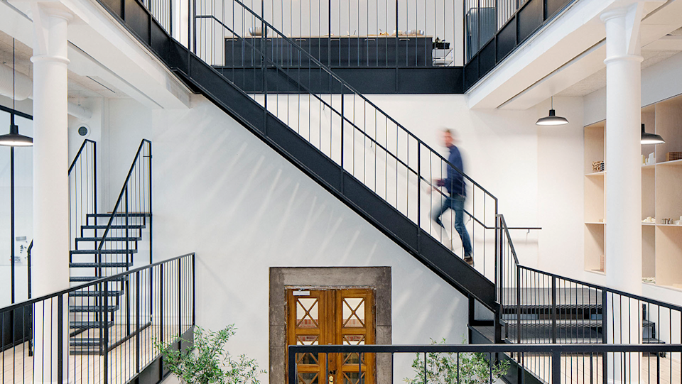 Image of a person going up a flight of stairs.