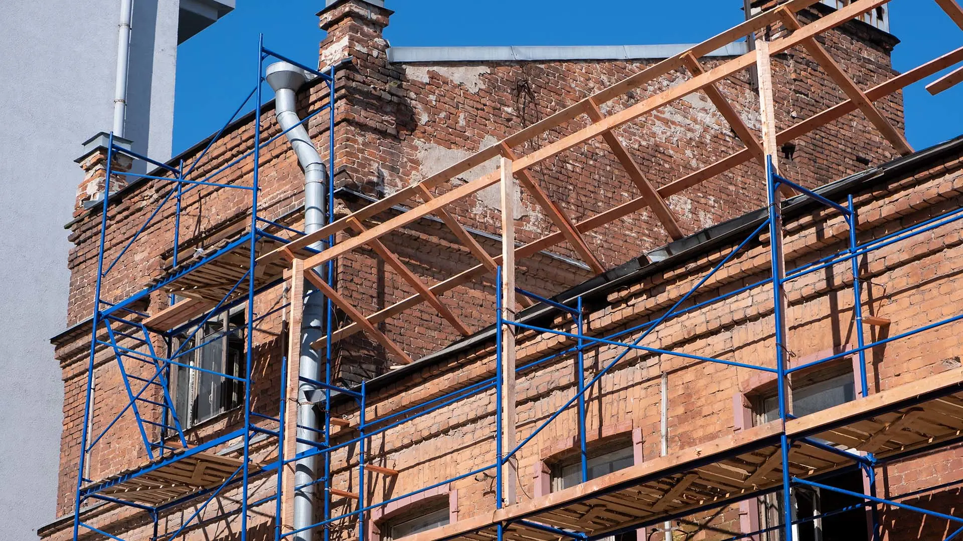 Scaffolding is seen on a historic brick building.