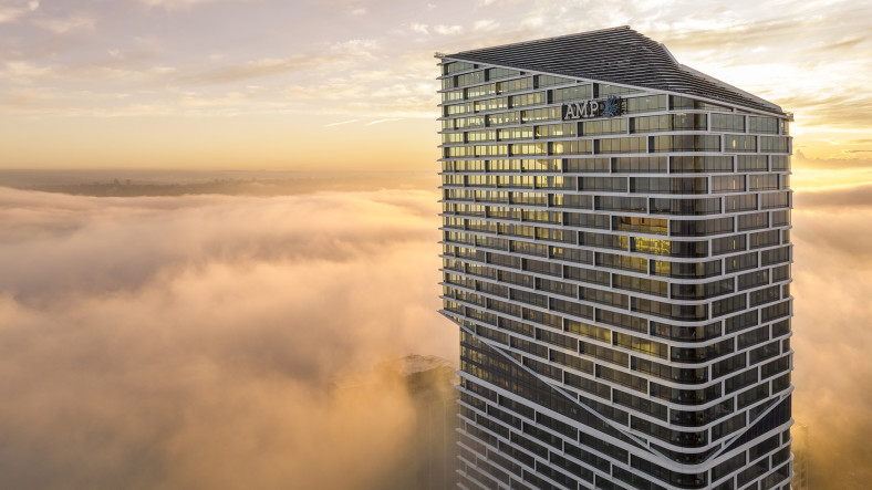 A skyscraper soars above the clouds