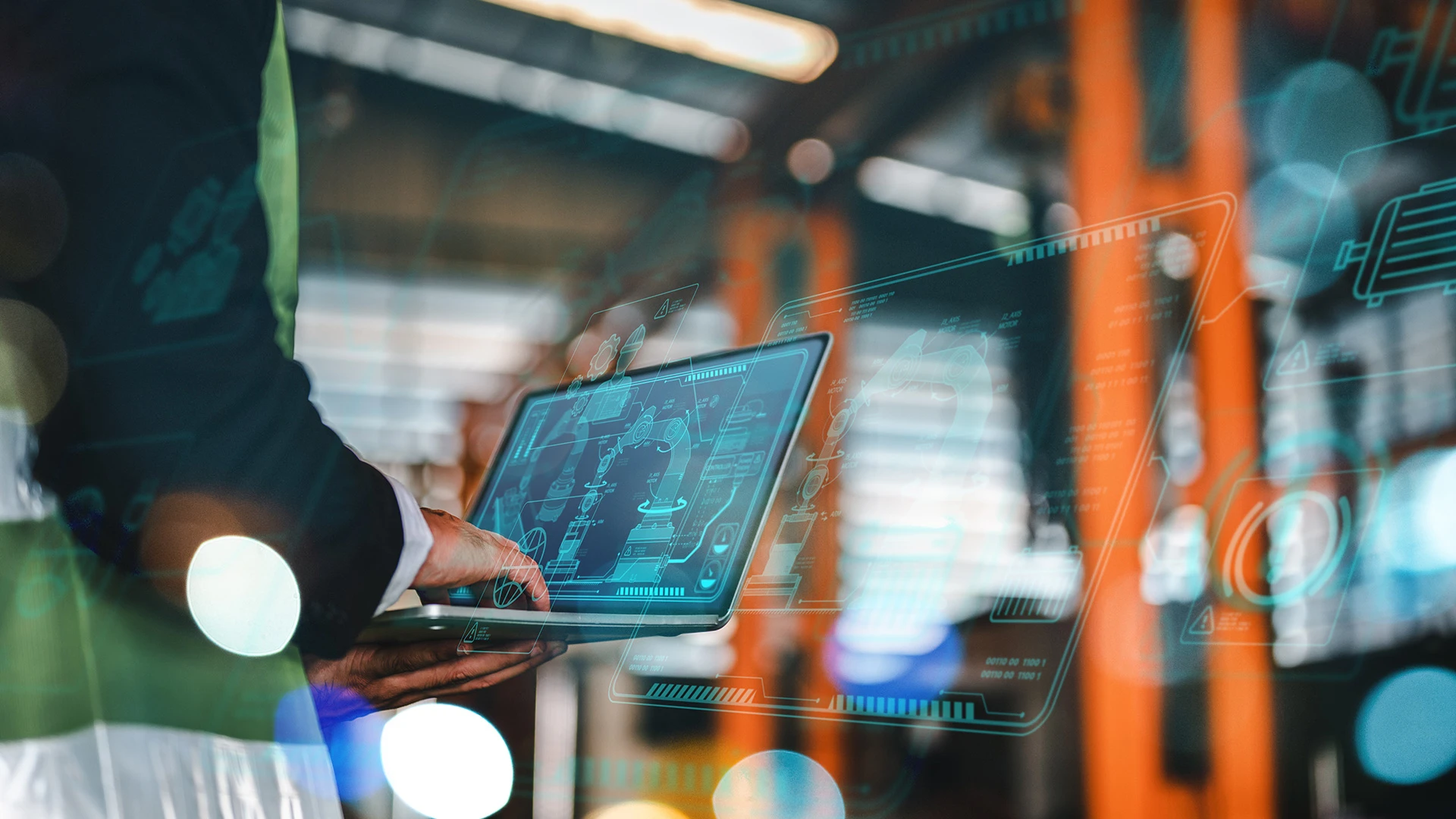 An engineer looks at a diagram of a machine on a tablet.