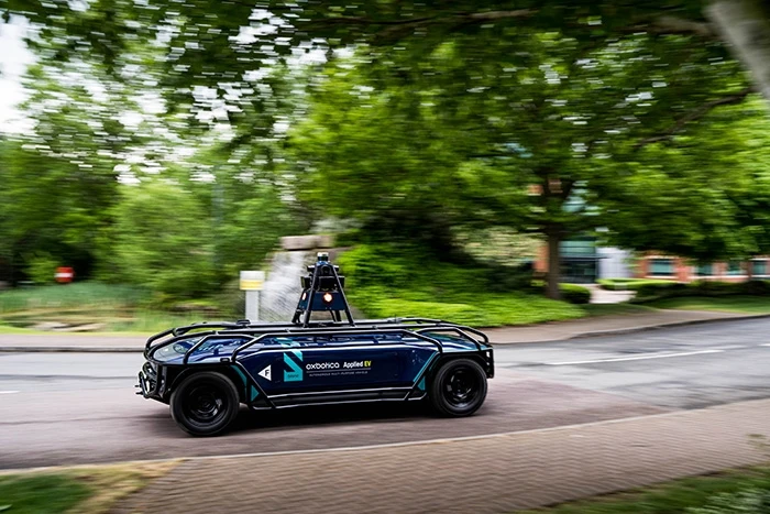 Black Oxbotica autonomous vehicle on road with blurred background