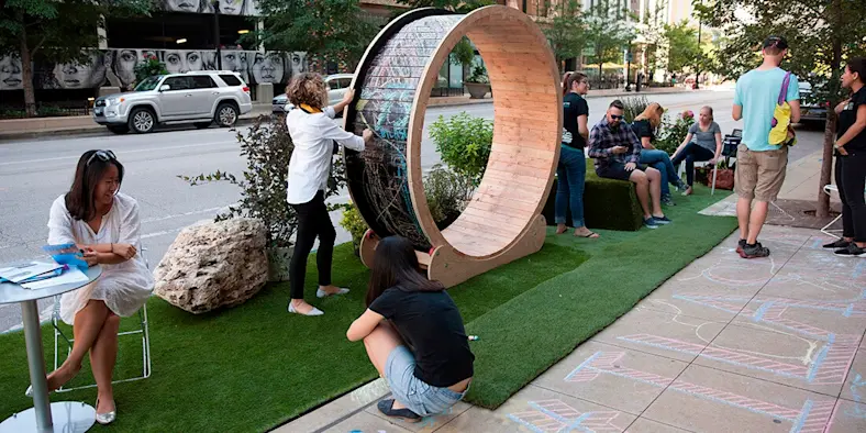 People mingle in a popup parklet in Chicago.