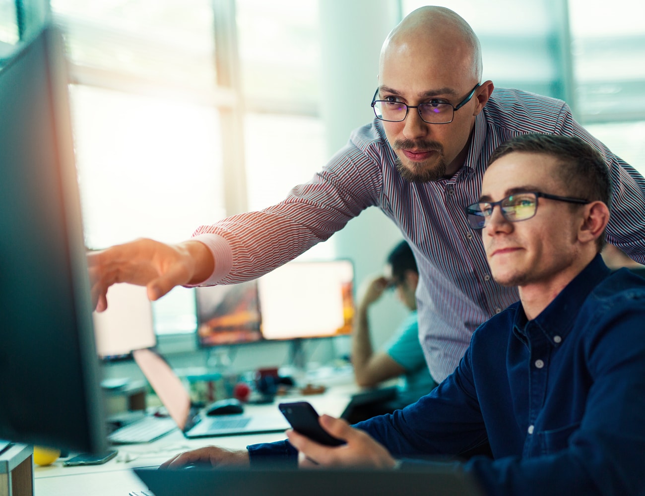 2 men reviewing bill of materials data