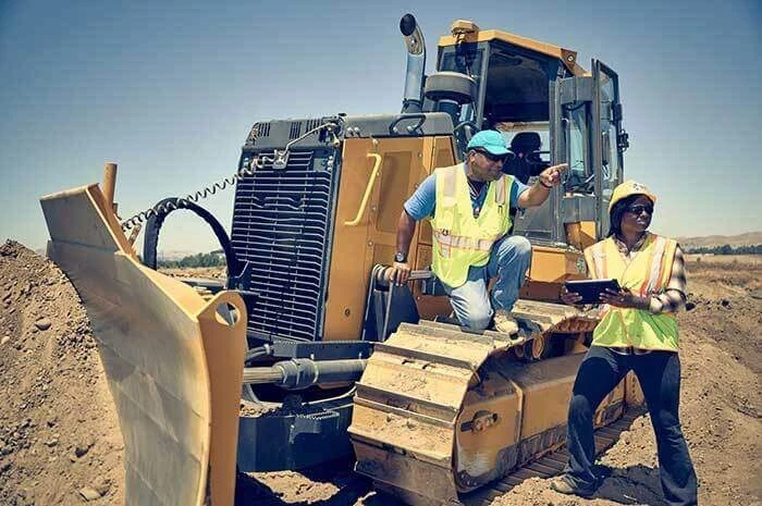 Two people on a construction site