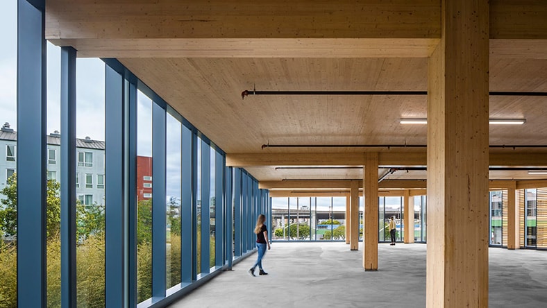 A woman exploring a large office space at San Francisco’s 1 De Haro featuring mass timber construction.