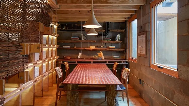 Dining room with wood floors and bookshelves.
