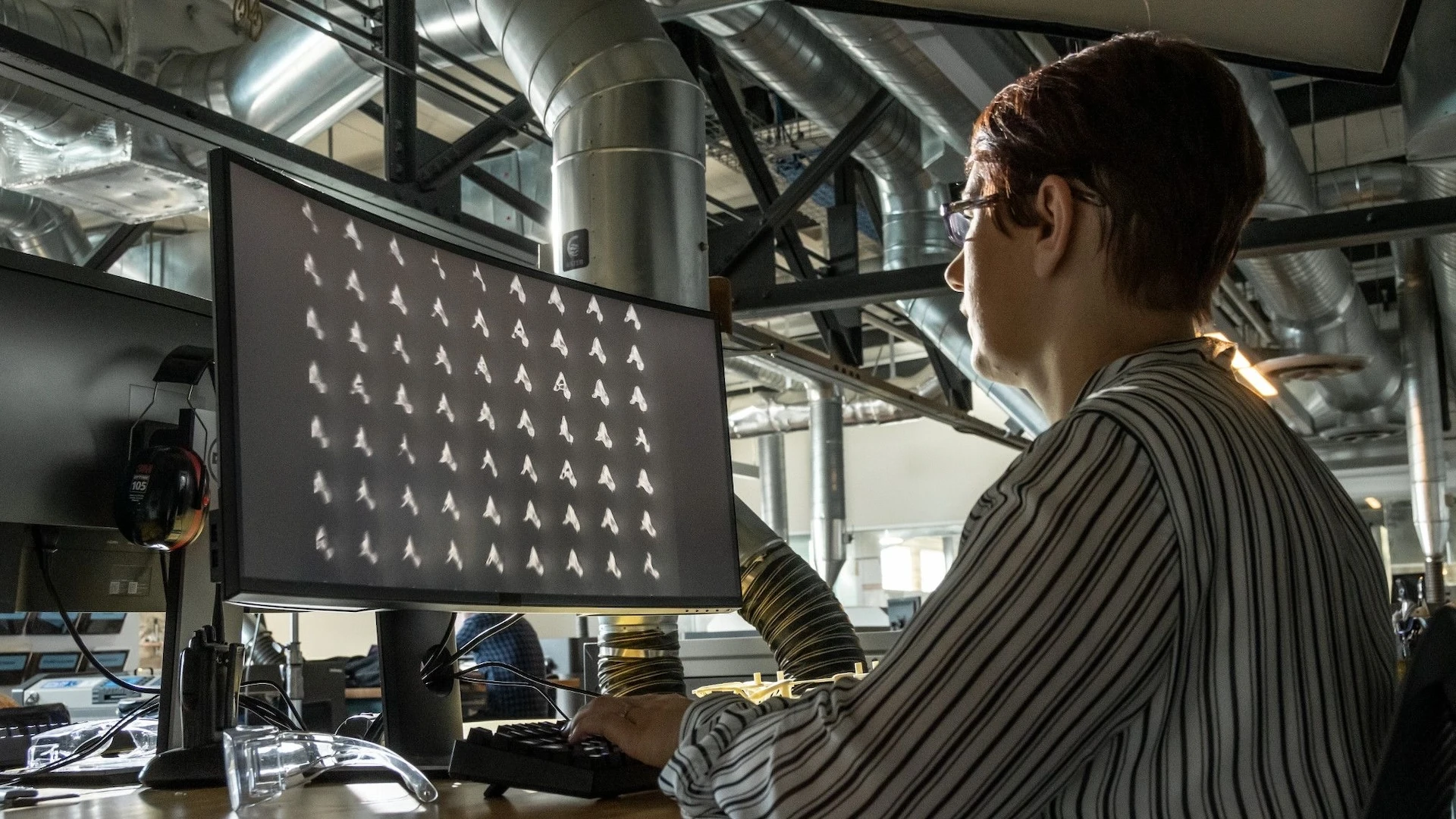 person looking at different design iterations on a computer
