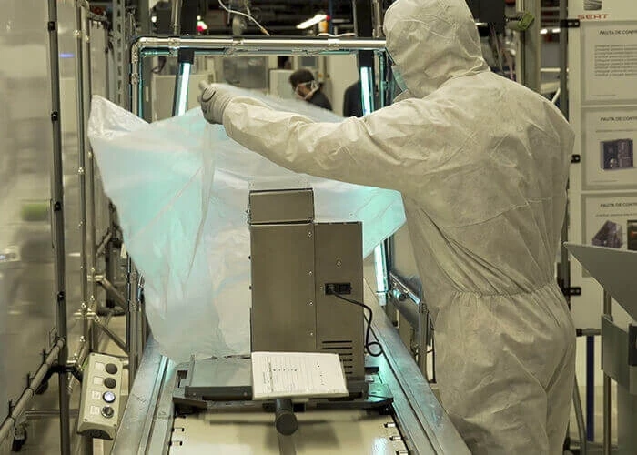Ventilator production worker in protective gear Seat assembly line