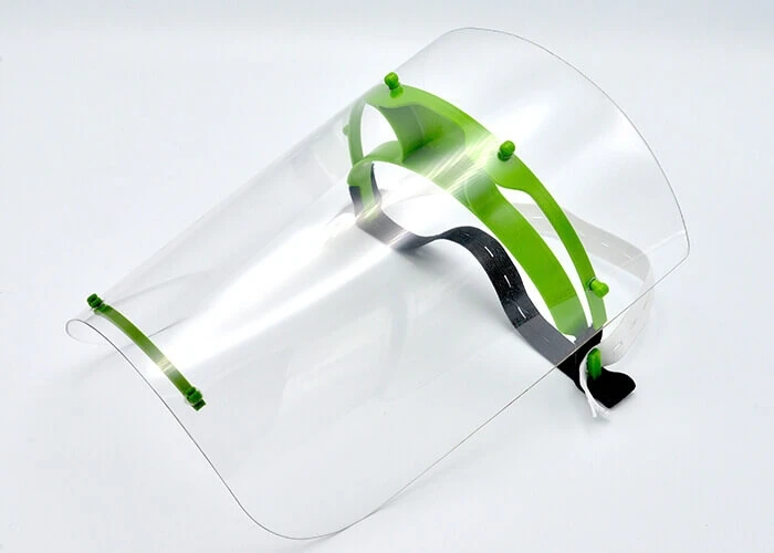 3D printed face shield with a clear plastic face guard mounted on a green headband.