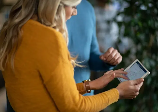 Woman and man looking at architectural drawing on a tablet marketing in architecture