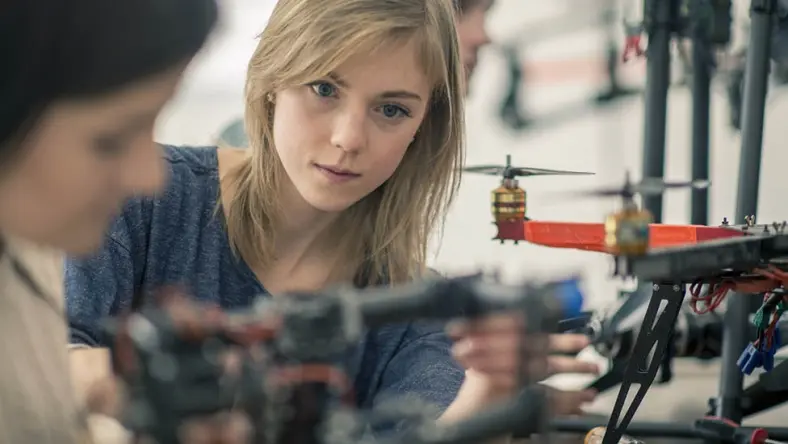 A woman working on a drone.