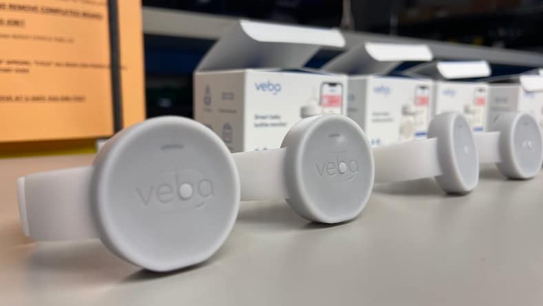 A series of tech wearables is displayed on a table.