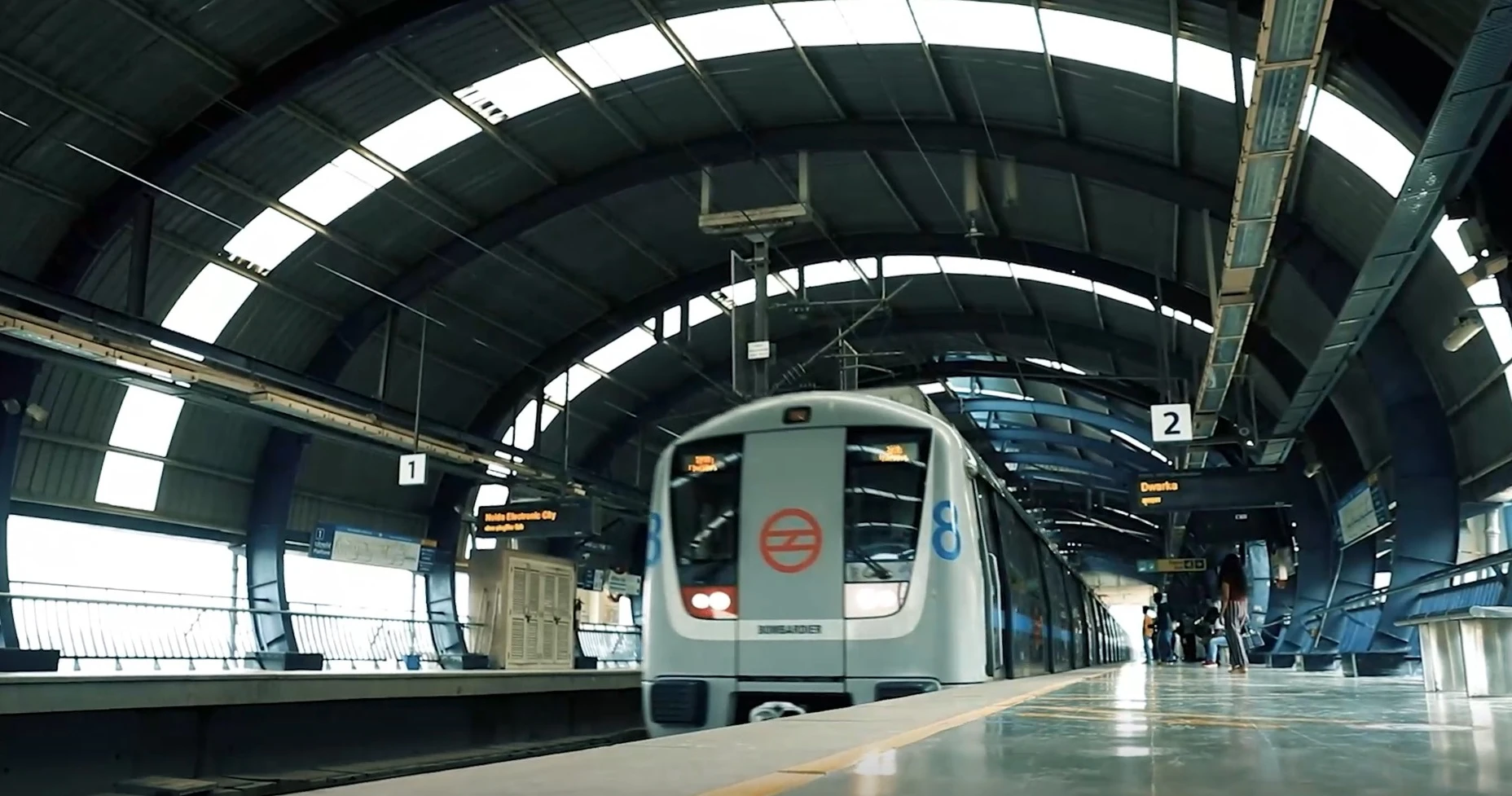 Silver Delhi Metro train coming into station