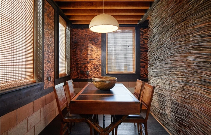 The Grass House interior, featuring panels “painted” with fire