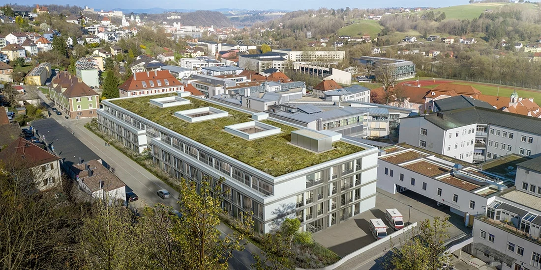 Aerial view of a hospital with a green roof