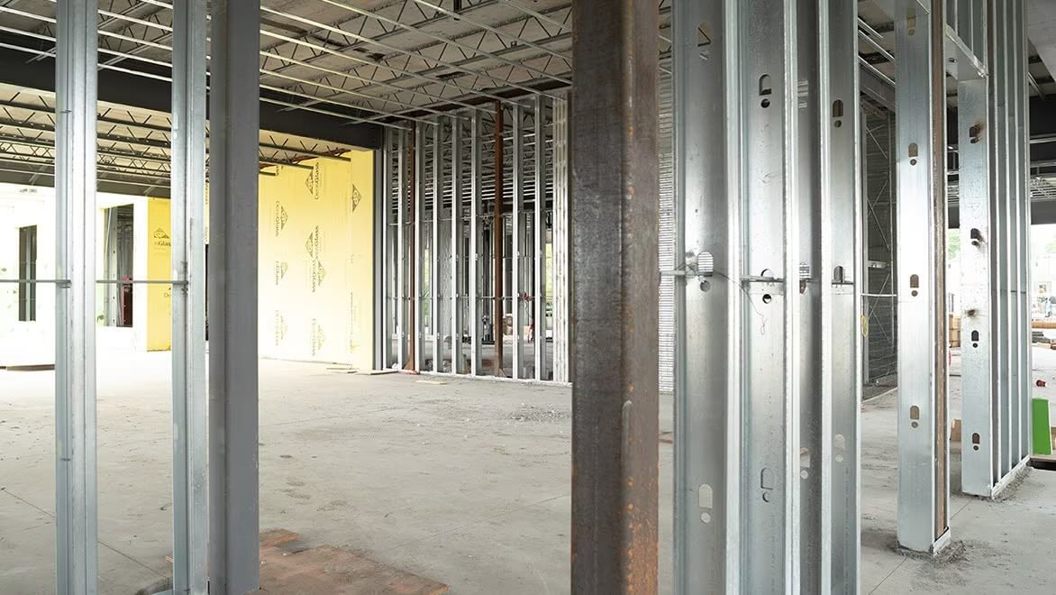 A building’s internal wall frames are built from steel.