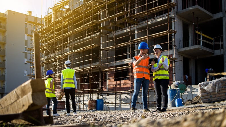 Man and women reviewing construction data.