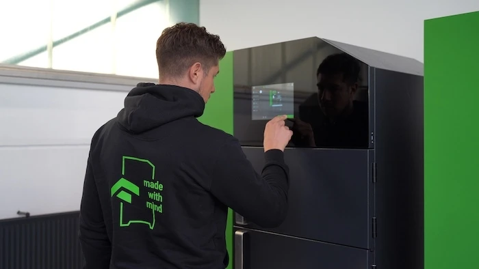 person using the MPRINT metal additive manufacturing machine
