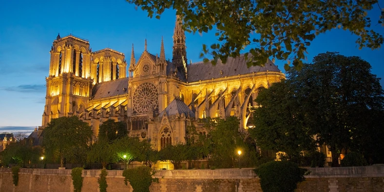 Notre-Dame de Paris lit in the evening sky
