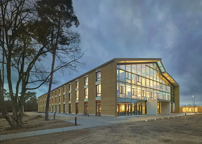 An image of Alnatura headquarters in Darmstadt, southwestern Germany, featuring a a facade made from rammed earth.