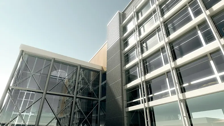 Modern glass and metal office building exterior under clear sky.