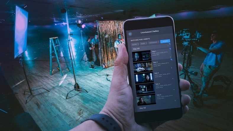 Creative review Autodesk Flow Capture camera-to-cloud smartphone showing dailies with film set in the background