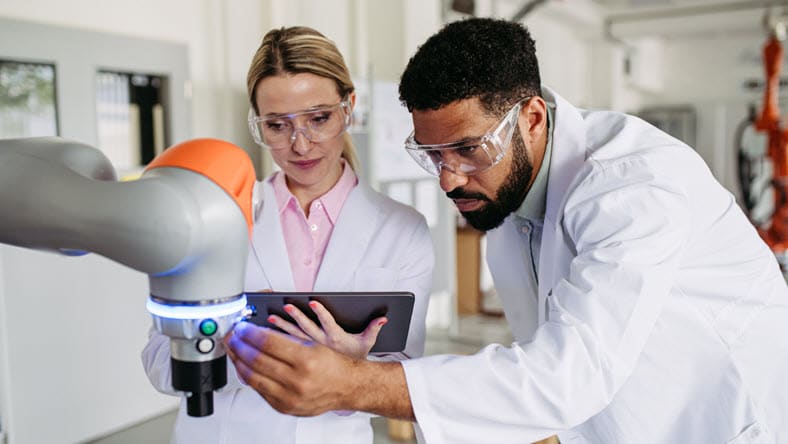 Robotic engineer colleagues working on robotic knee replacement surgery project