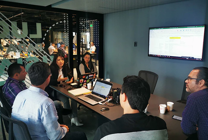 Colombian construction executives gather in a conference room.