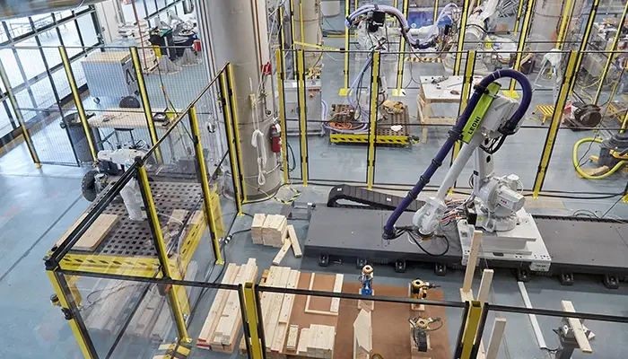 A construction robot assembles lumber structures.