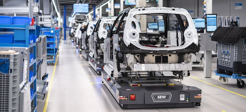 Electric car components being transported across factory