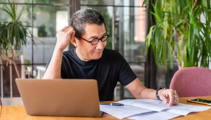 A remote worker sits at his desk at home