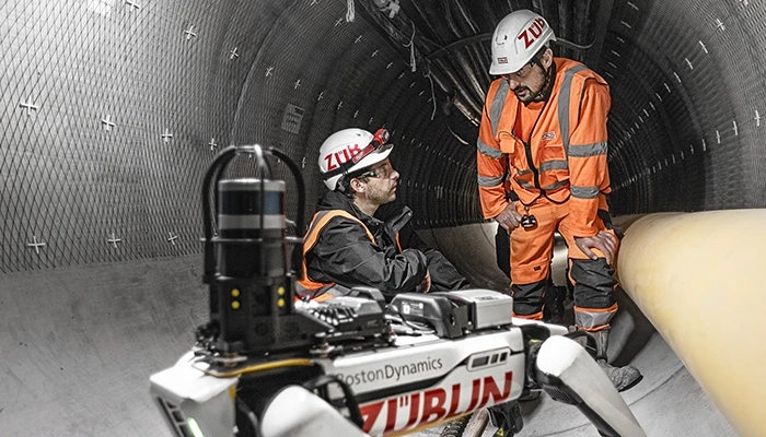 people in hardhats in a tunnel