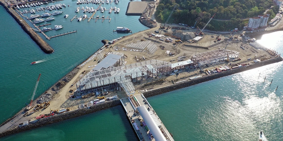 Aerial view of a building on a piece of land surrounded by water