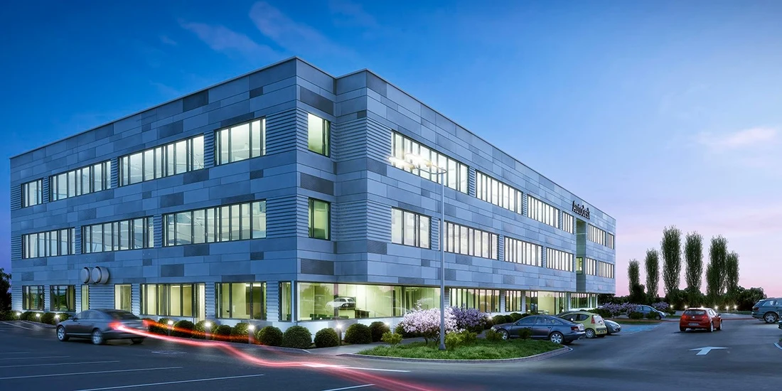Rendering of a two-story office building at dusk