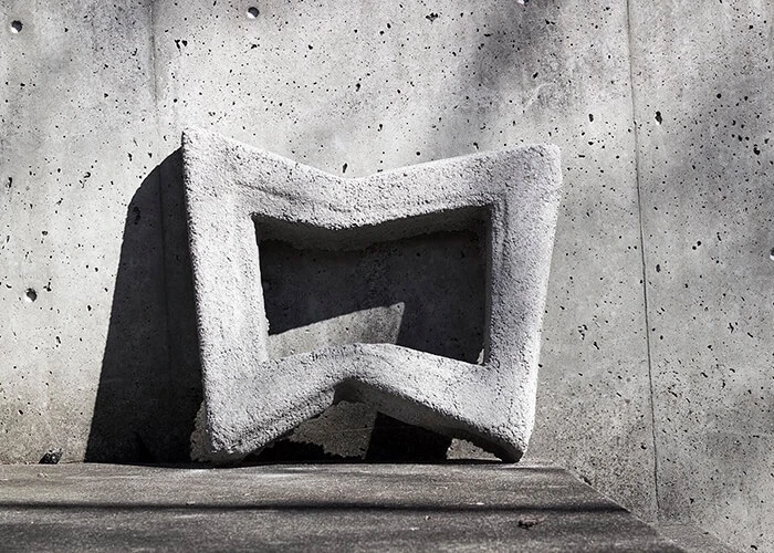 A concrete panel features angular accents.