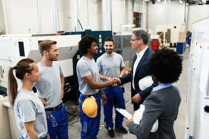 manufacturing employees shaking hands