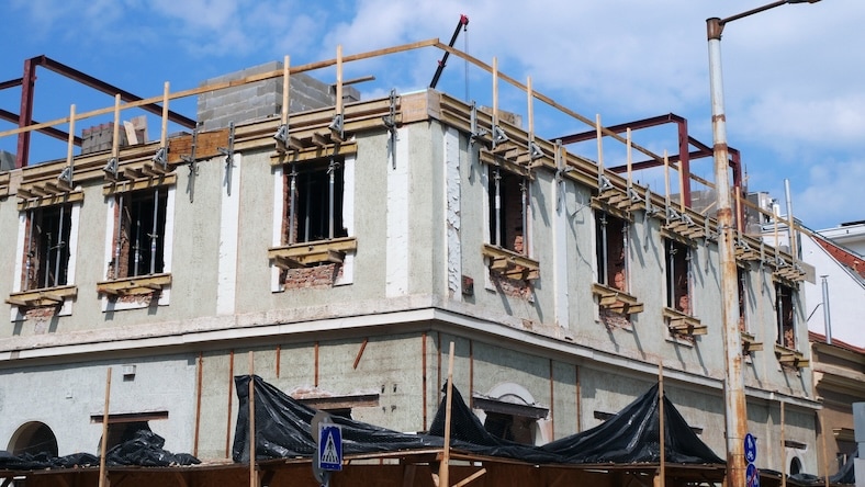 A brick building is being retrofitted.