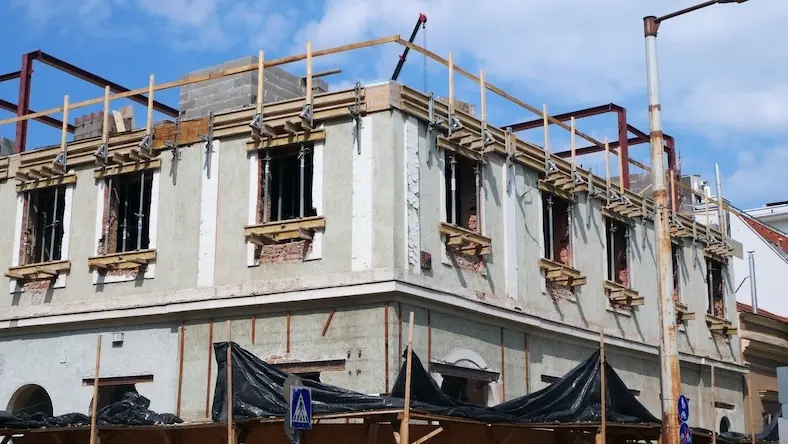 A brick building is being retrofitted.