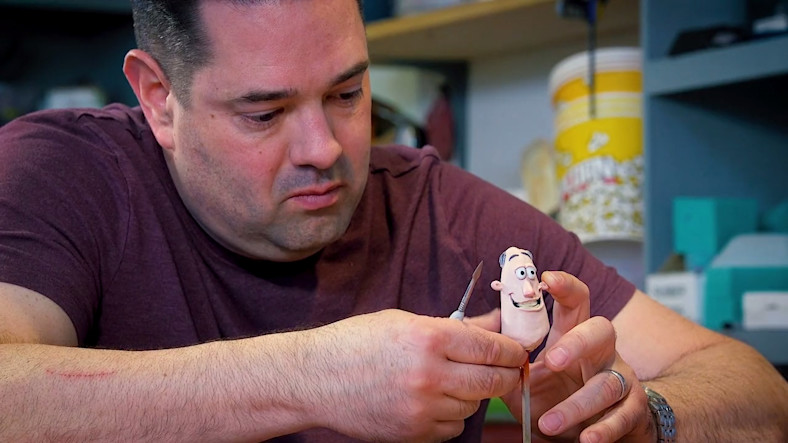 HouseSpecial Animator Chris Ohlgren works on the head of a clay character for stop-motion animation.