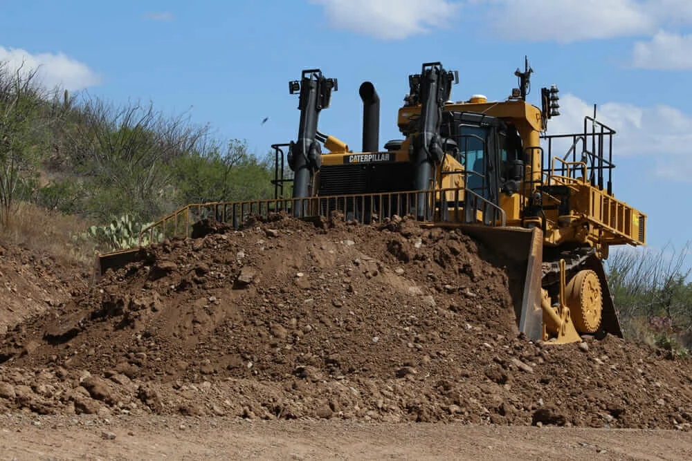 Autonomous dozer pushing dirt pile