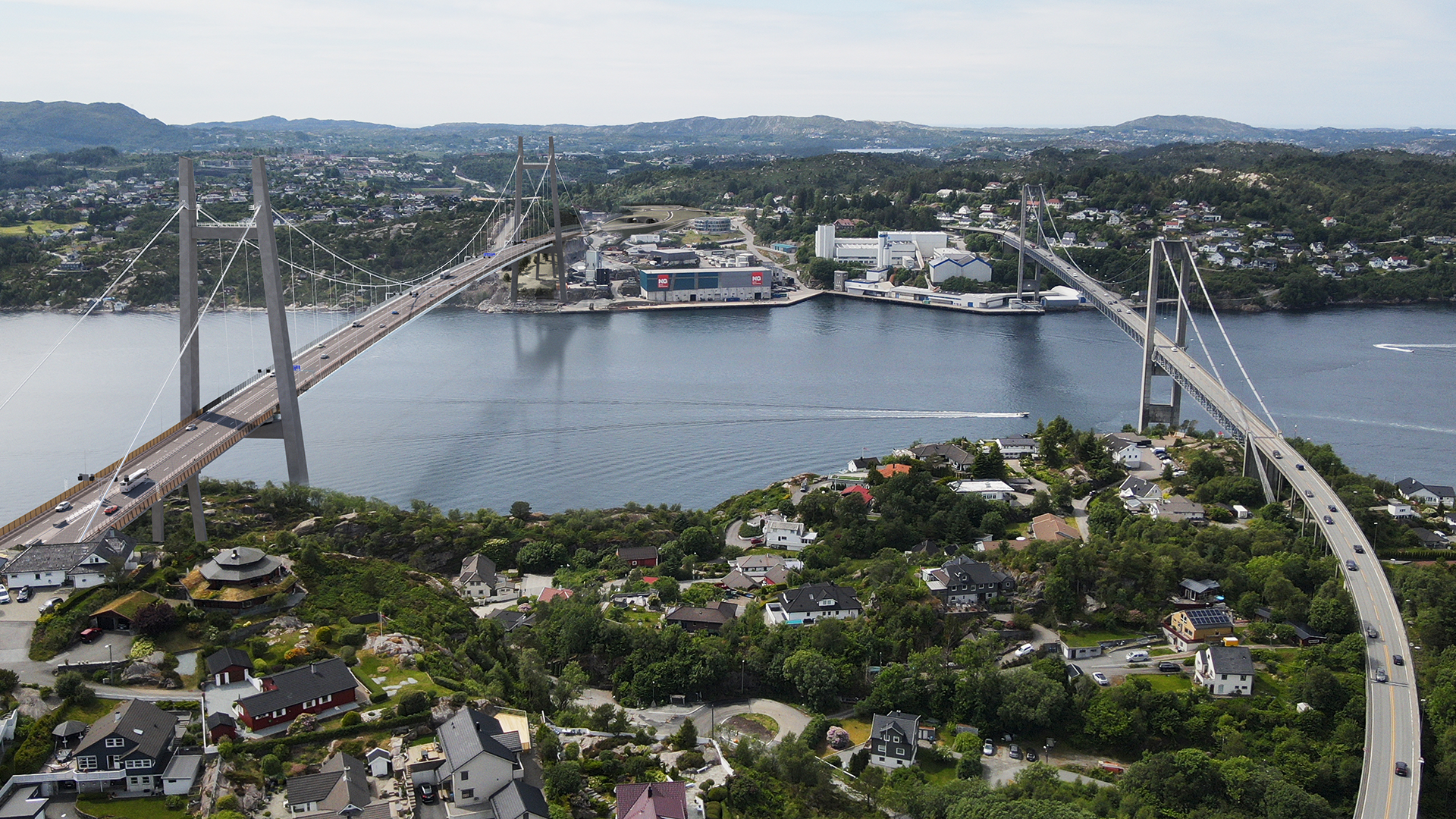  In a rendering, an aerial view of a suspension bridge connects two areas across a waterway, with cars traveling in both directions and residential homes visible in the foreground.