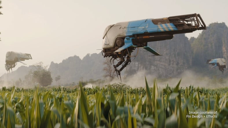 In this video game still, large, futuristic vehicles hover over a cornfield.
