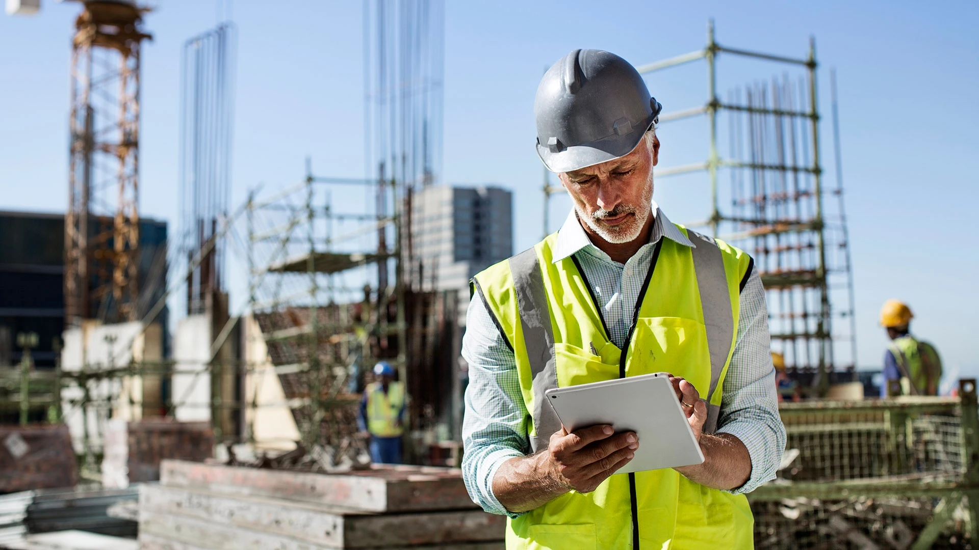 person using an iPad on a construction site