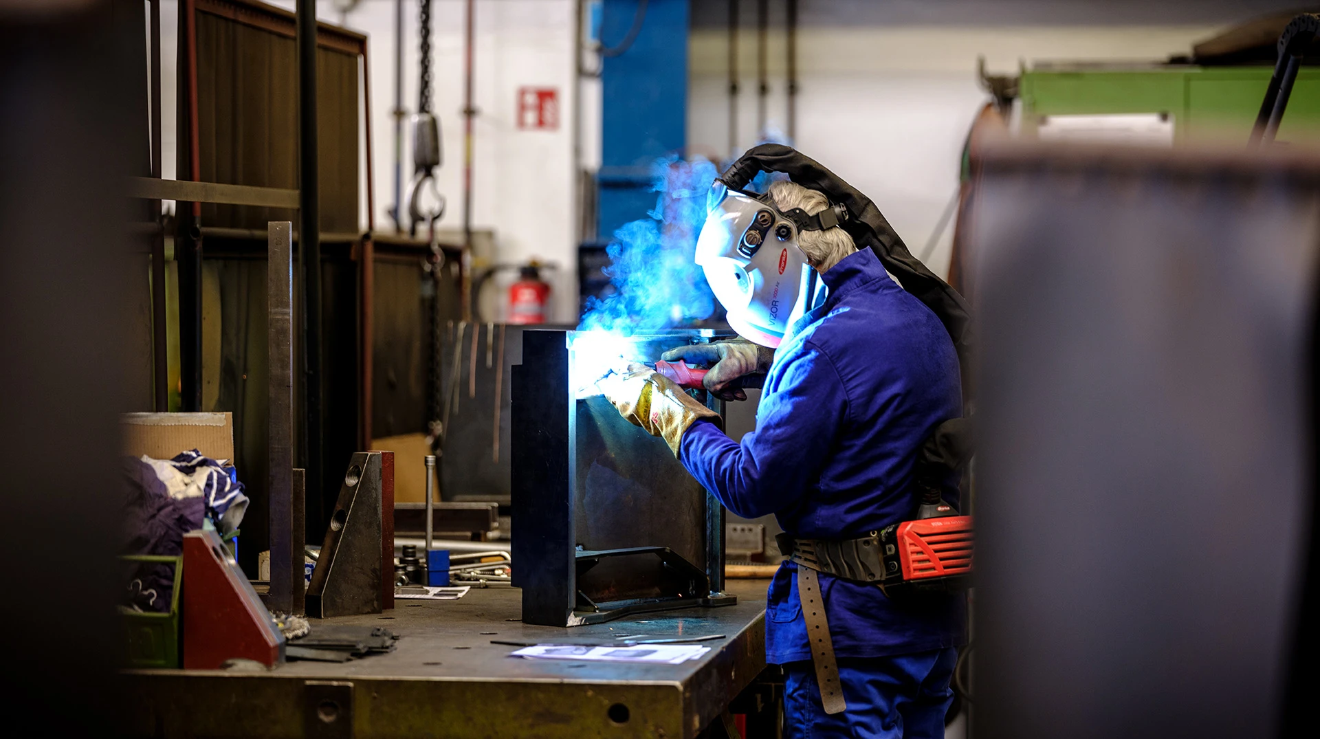 A worker welding pieces of metal together