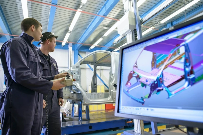 An automotive team working on a vehicle body in software