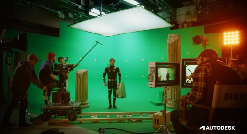 Image showing the future of media and entertainment where actor is on set with production crew in front of green screen hooked up to nodes to track movements